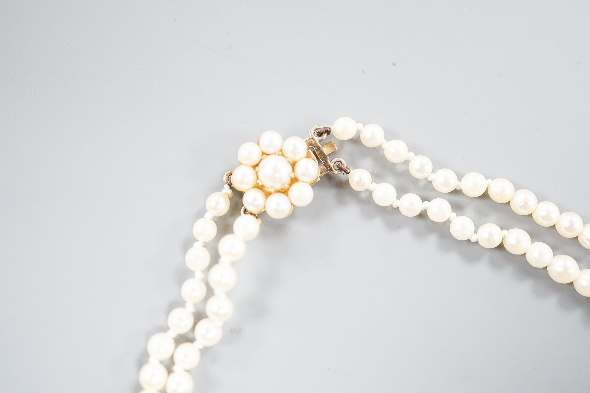 A double strand cultured pearl necklace, with 9ct and cultured pearl cluster clasp, 43cm.